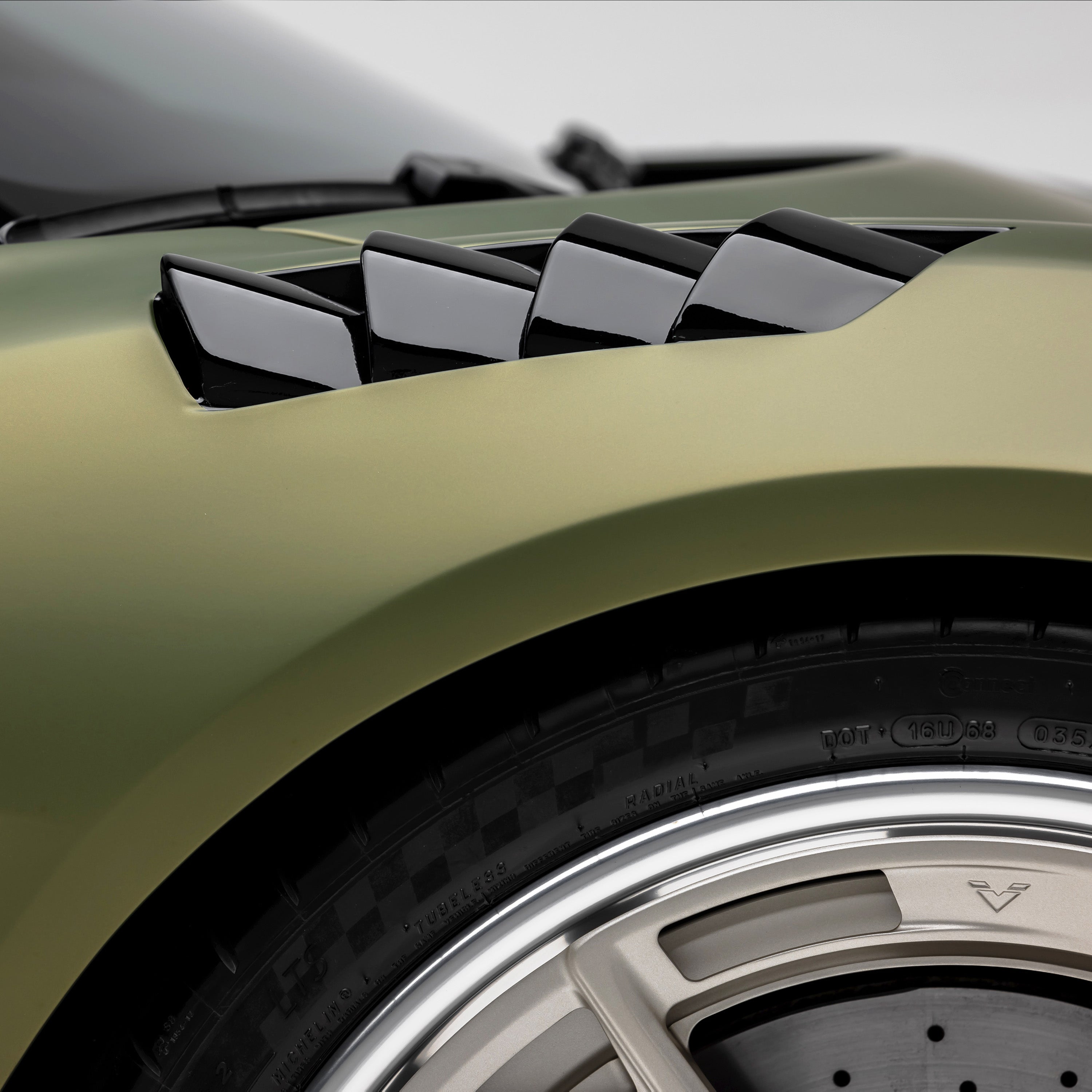 LR-52 fender vents over Emira front wheel, side close-up
