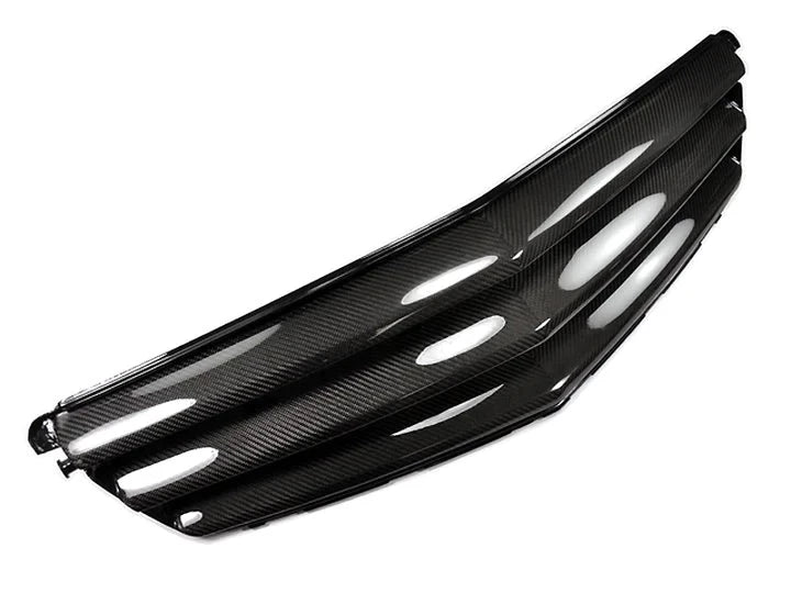 A front side view of AUTOTECKNIC REPLACEMENT CARBON FIBER FRONT GRILLE - MERCEDES BENZ W204 C-CLASS SEDAN 2008-2012 with white background