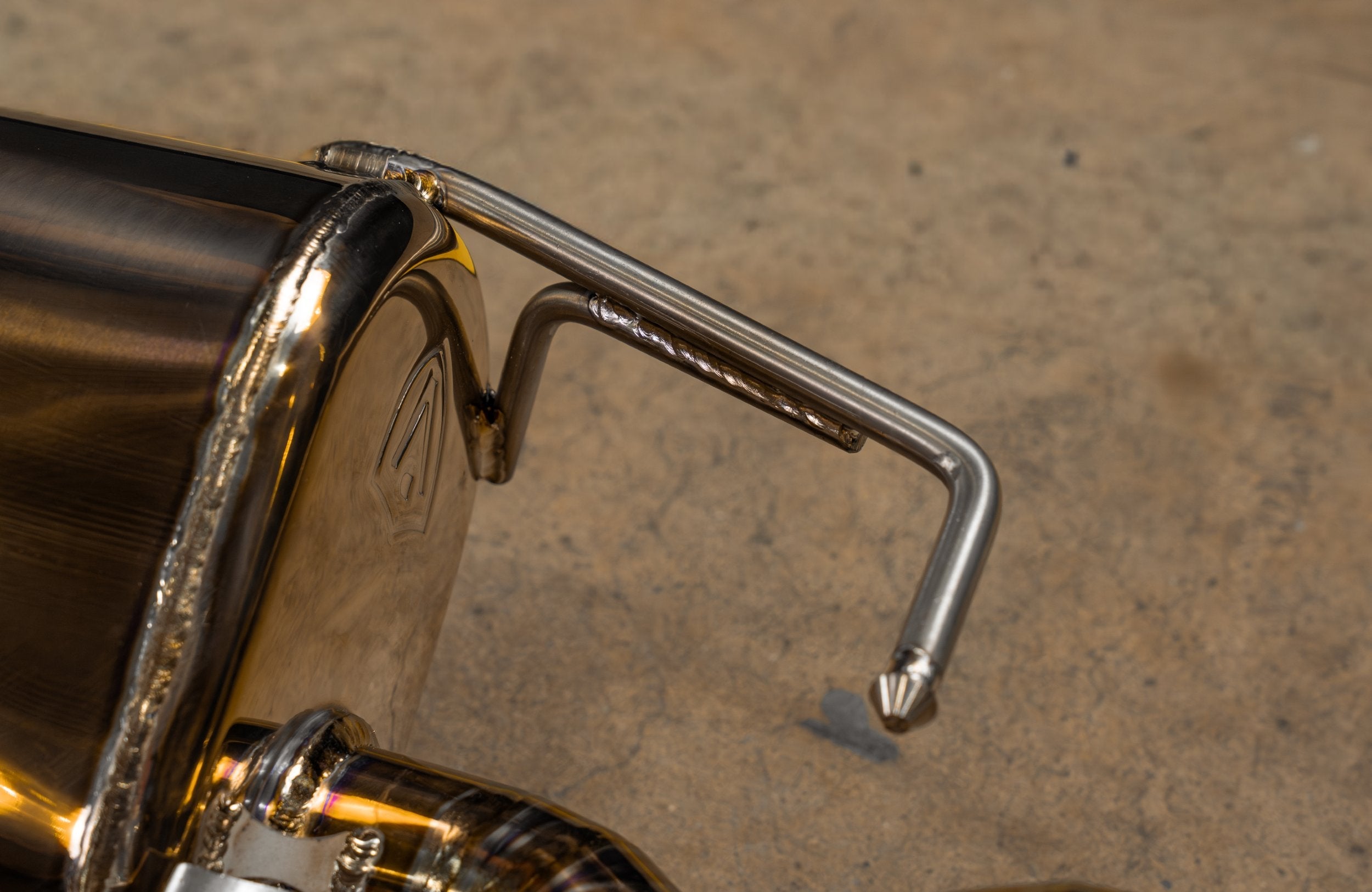 Valvetronic Designs Valved Exhaust AMG GT63 X290 manufacturer gallery: bent hanger beside the gold-toned rear muffler