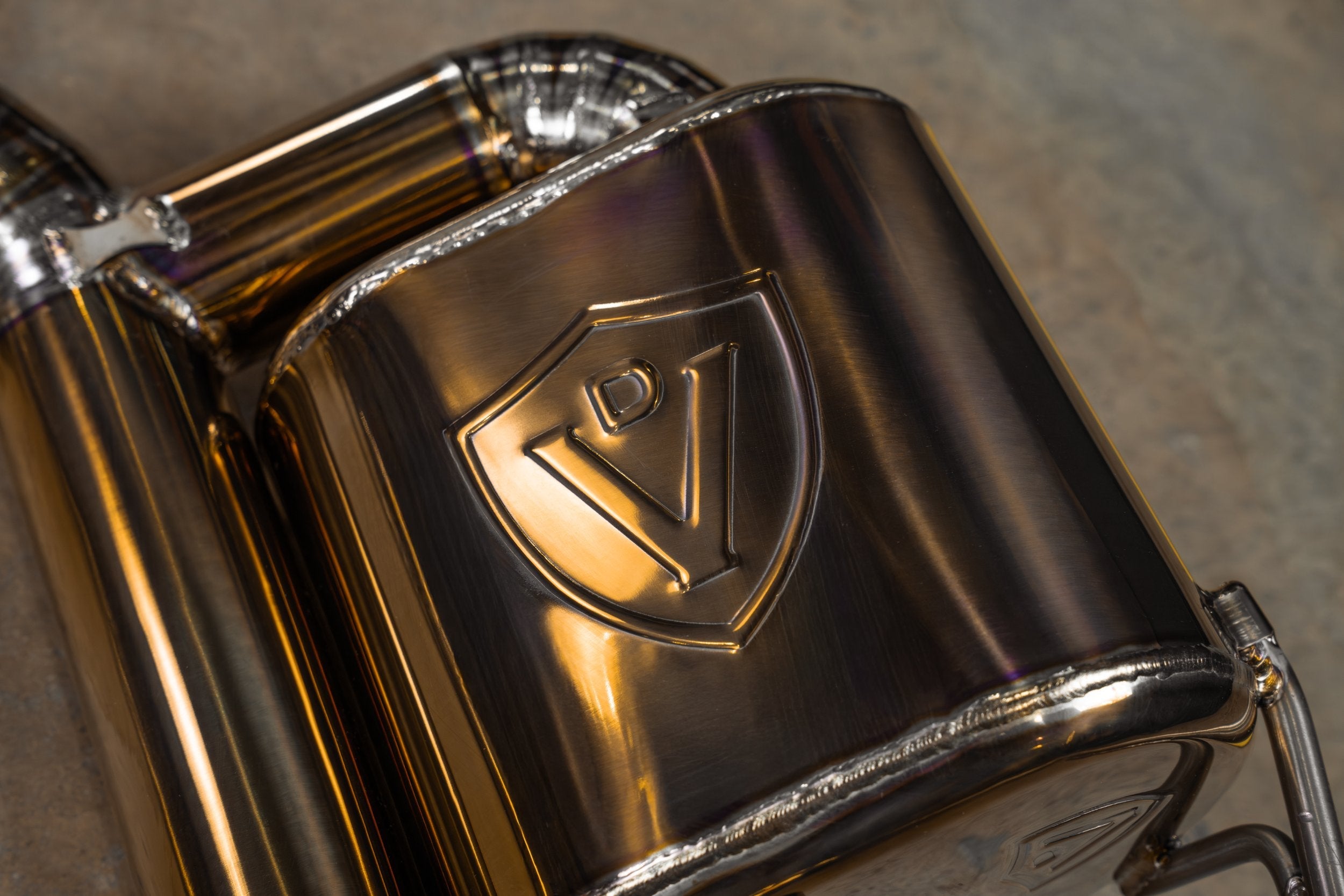 Valvetronic Designs Valved Exhaust AMG GT63 X290 manufacturer gallery: embossed shield on the gold-toned muffler housing