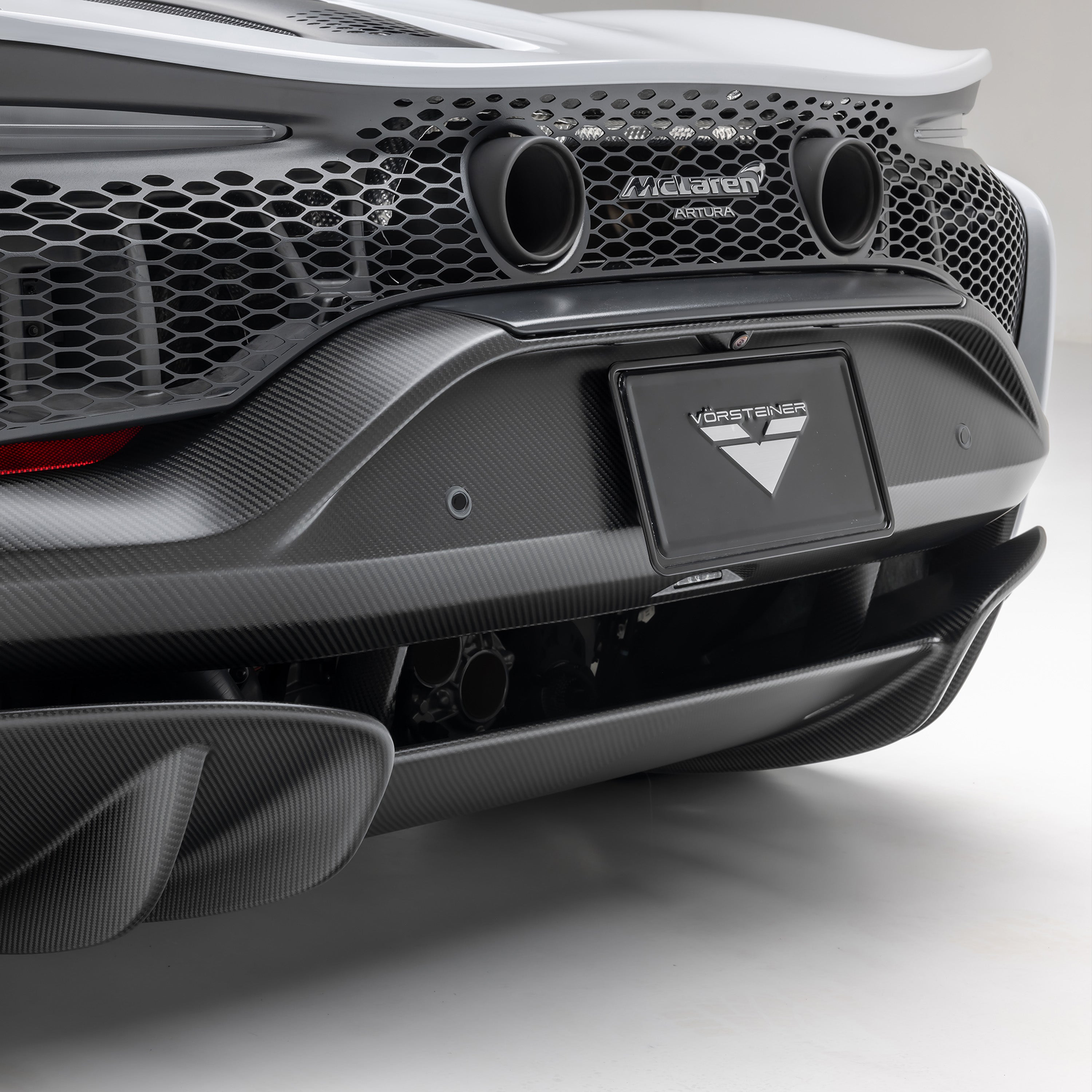 Carbon Artura rear bumper and exhausts, rear 3/4 close-up