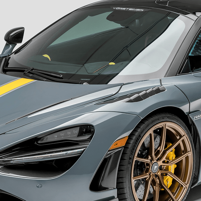 A side view of a car fitted with Vorsteiner Silverstone Edition Glossy Carbon Fiber PP 2x2 Aero Front Fenders w/ Integrated Vents McLaren 720S 2017+