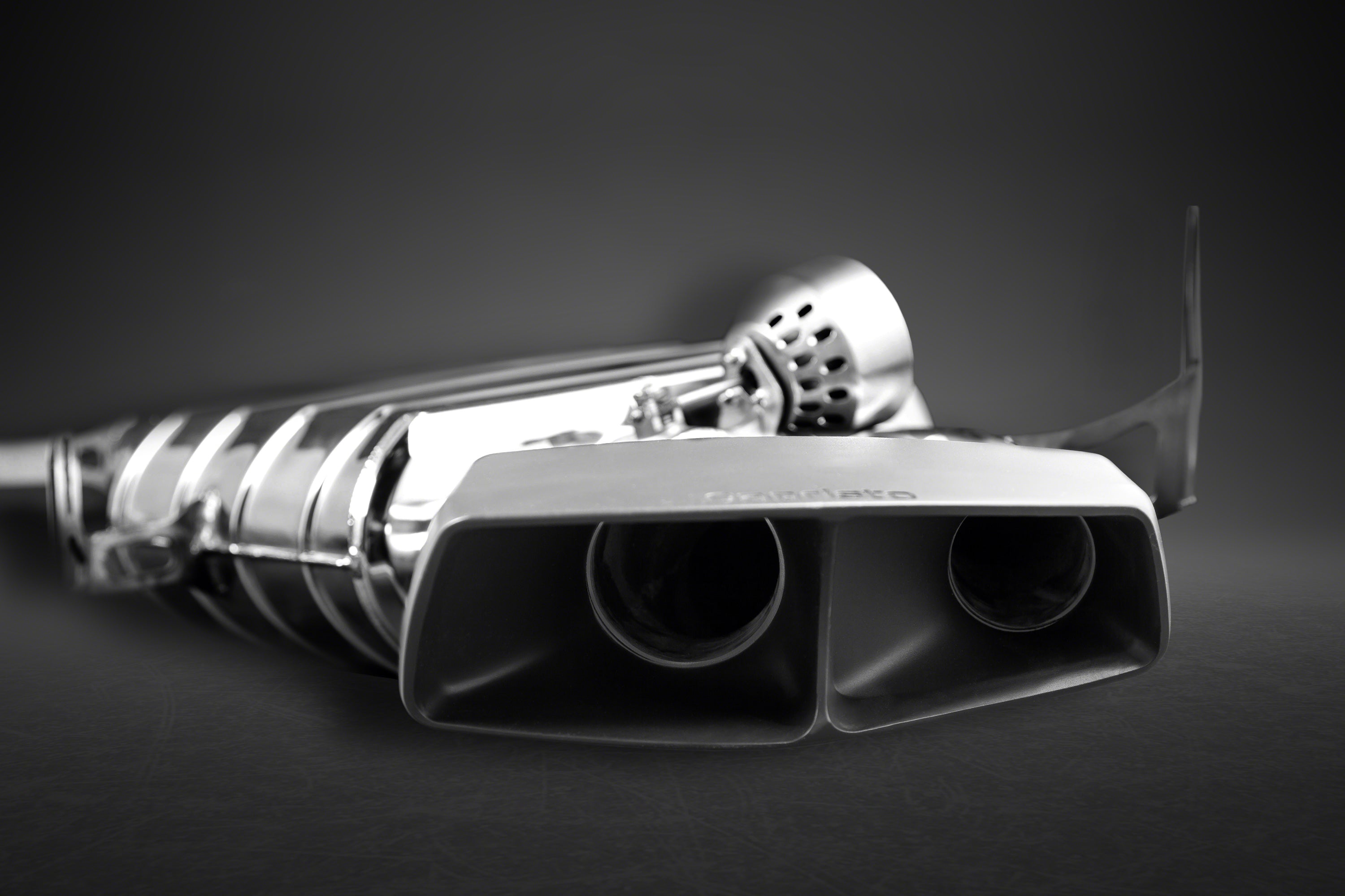Close-up of black ceramic twin-outlet rectangular tip on Capristo ML63 W164 muffler