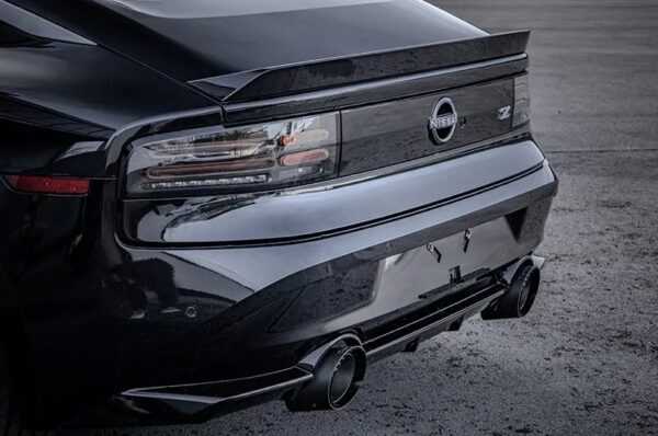 wide side view of Capristo Valved Exhaust with Center Silencer Delete and Carbon/Wicrom Tips (CES3) for Nissan Z (RZ34) 2023-2025 fitted inside a car