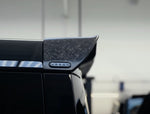 A close up view of Urban Automotive Octa Limited Edition Forged Carbon Upper Rear Spoiler for Land Rover Defender OCTA 2025 fitted on a car