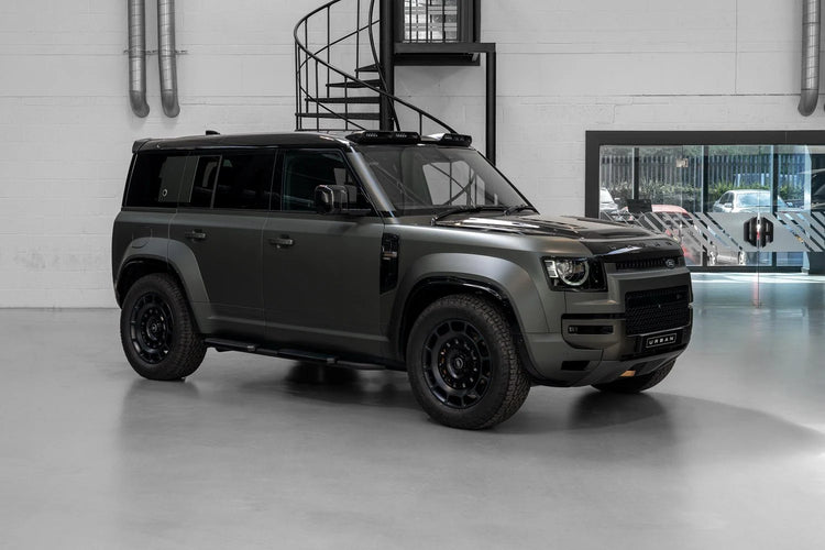 A wide side view of Urban Automotive Octa Limited Edition Forged Carbon Front Fender Side Vents for Land Rover Defender OCTA 2025 fitted on a car