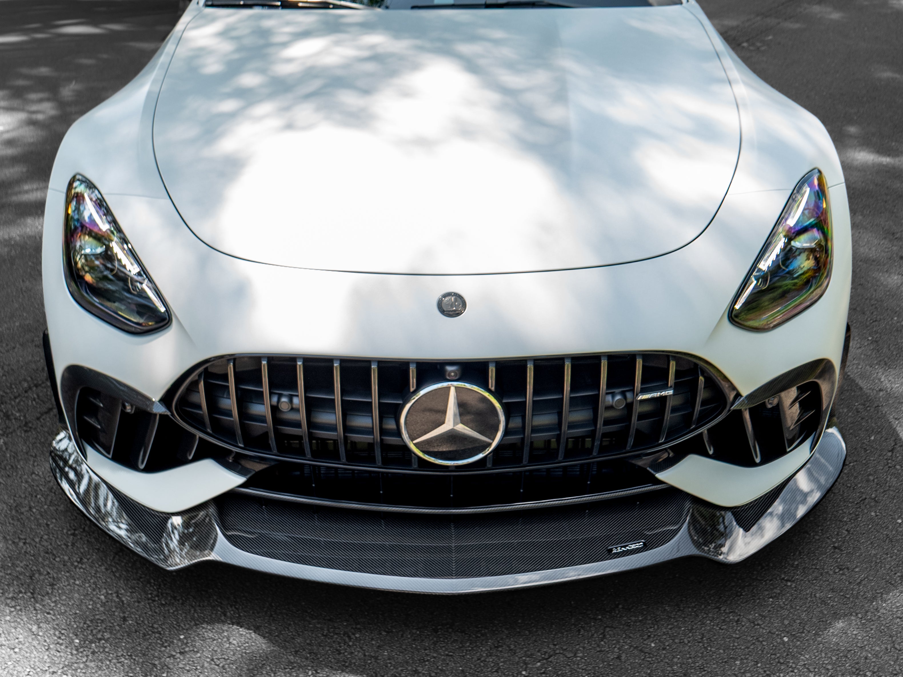 Overhead front view of a white C192 AMG GT with the carbon splitter installed