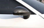 A close up view of AUTOTECKNIC REPLACEMENT CARBON FIBER MIRROR COVERS - PORSCHE 991 CARRERA | 981 CAYMAN / BOXSTER 2012+ fitted on a white car