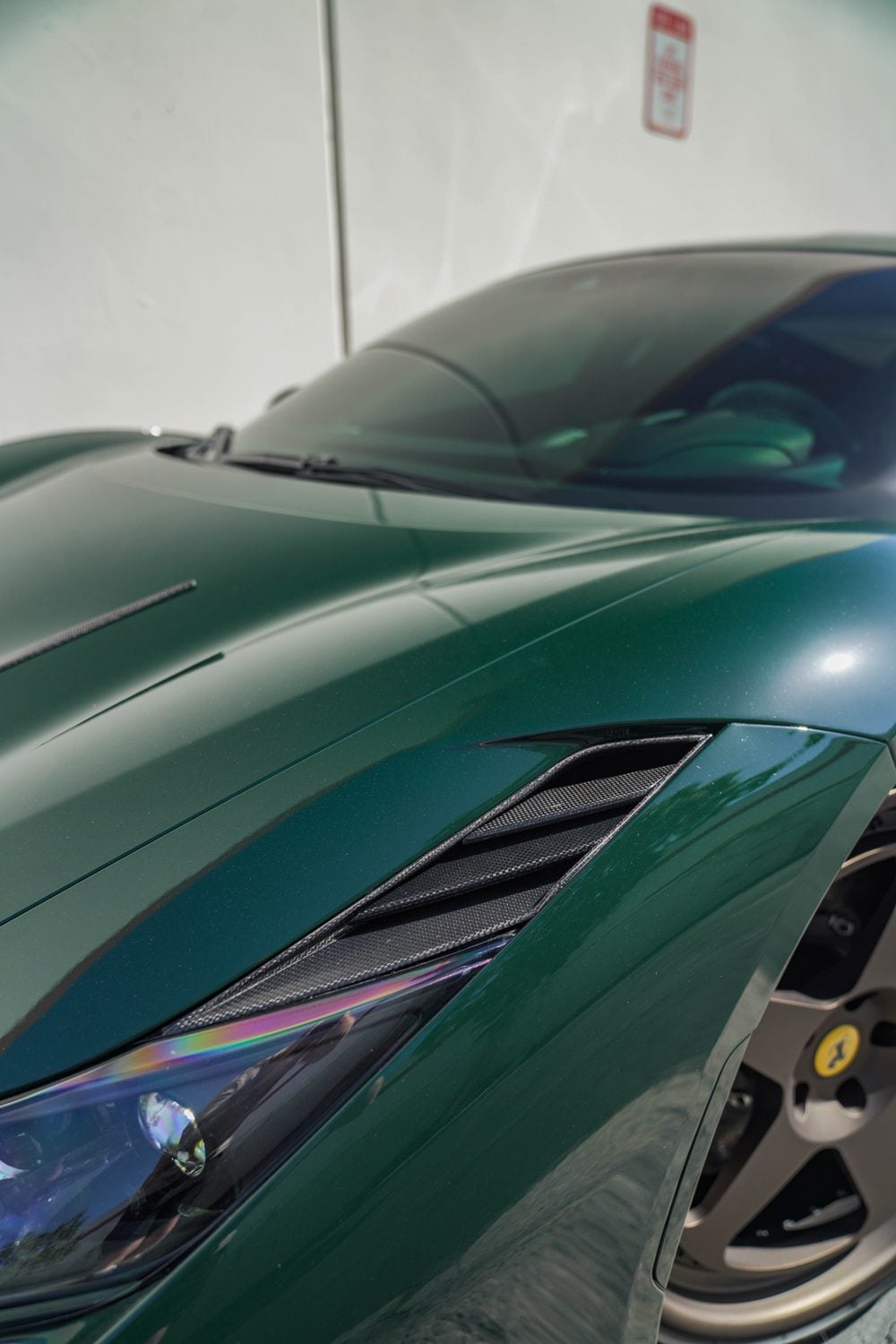 Carbon headlamp trim on a green Ferrari F8 Tributo