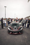 Black McLaren 570S front view with the complete aero kit in front of a crowd