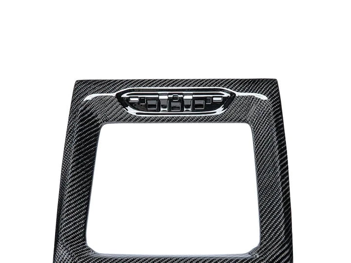 A close up view of AUTOTECKNIC CARBON FIBER CENTER CONSOLE - BMW F97 X3M | F98 X4M LCI 2021+ with white background