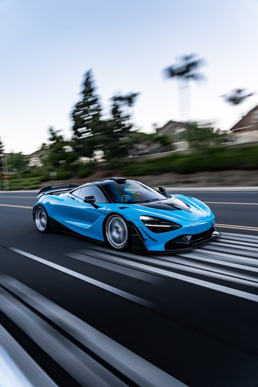 Blue McLaren 720S rolling shot with carbon dive canards