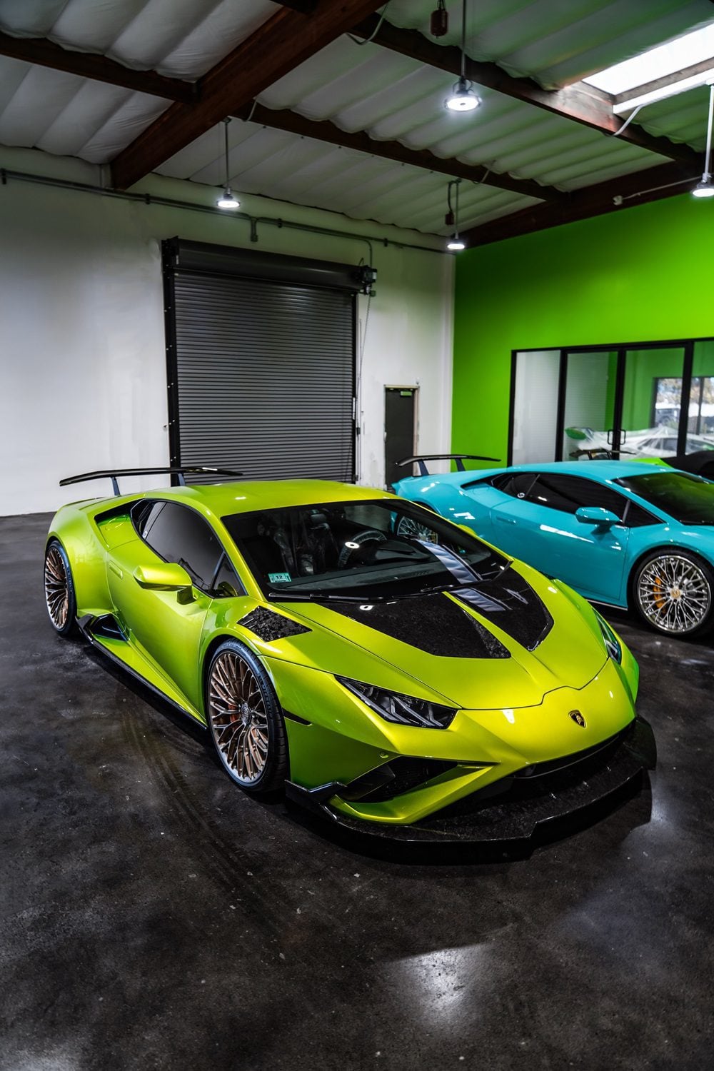 Lime green Lamborghini Huracan Evo front three-quarter with carbon race hood in a garage