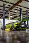 Lime green Lamborghini Huracan Evo rear three-quarter showing the carbon rear diffuser in a garage