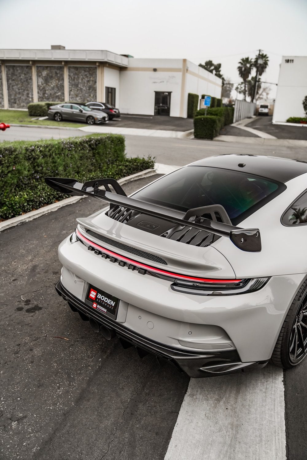 Grey Porsche 911 GT3 (992) overhead rear view with carbon wing blade