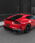Red Ferrari 812 rear three-quarter showing the carbon rear spoiler