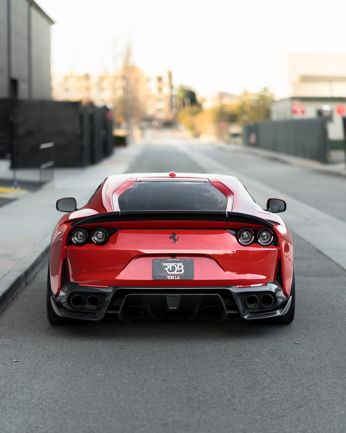 Red Ferrari 812 straight rear view showing the rear center diffuser