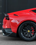 Carbon rear spoiler on a red Ferrari 812, rear quarter close-up