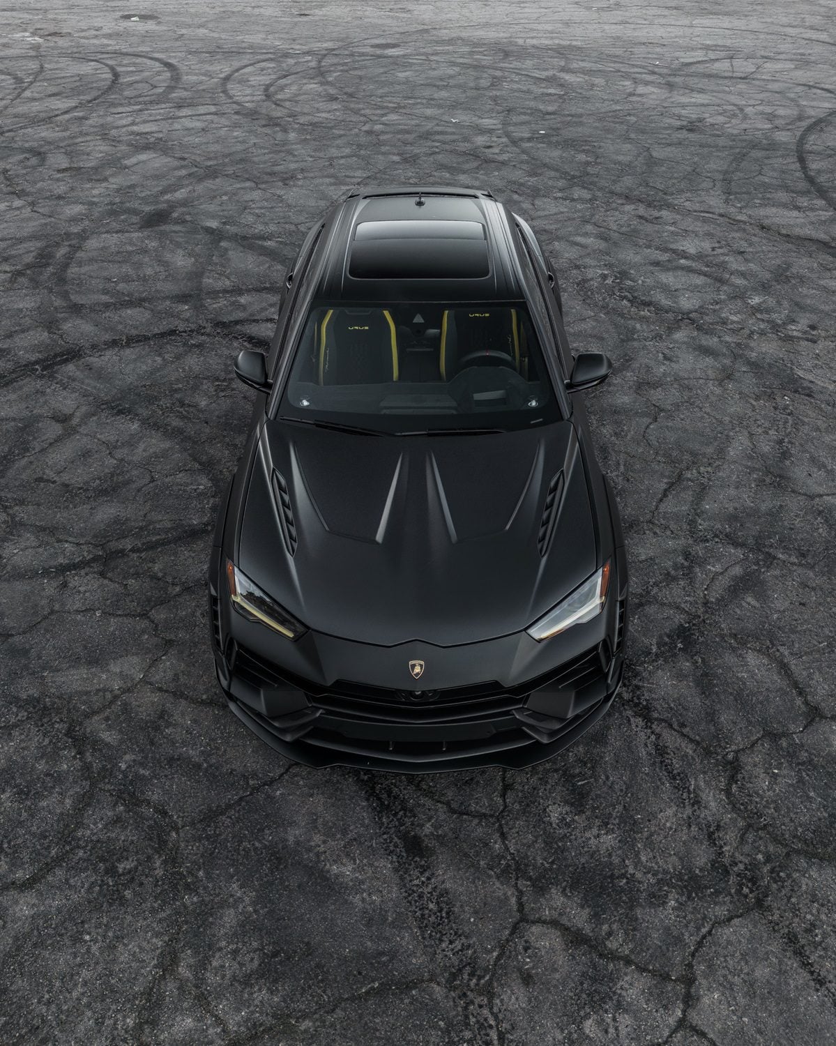 Black Lamborghini Urus overhead front view showing the vented hood