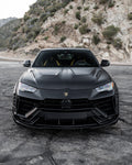 Black Lamborghini Urus head-on on a mountain road