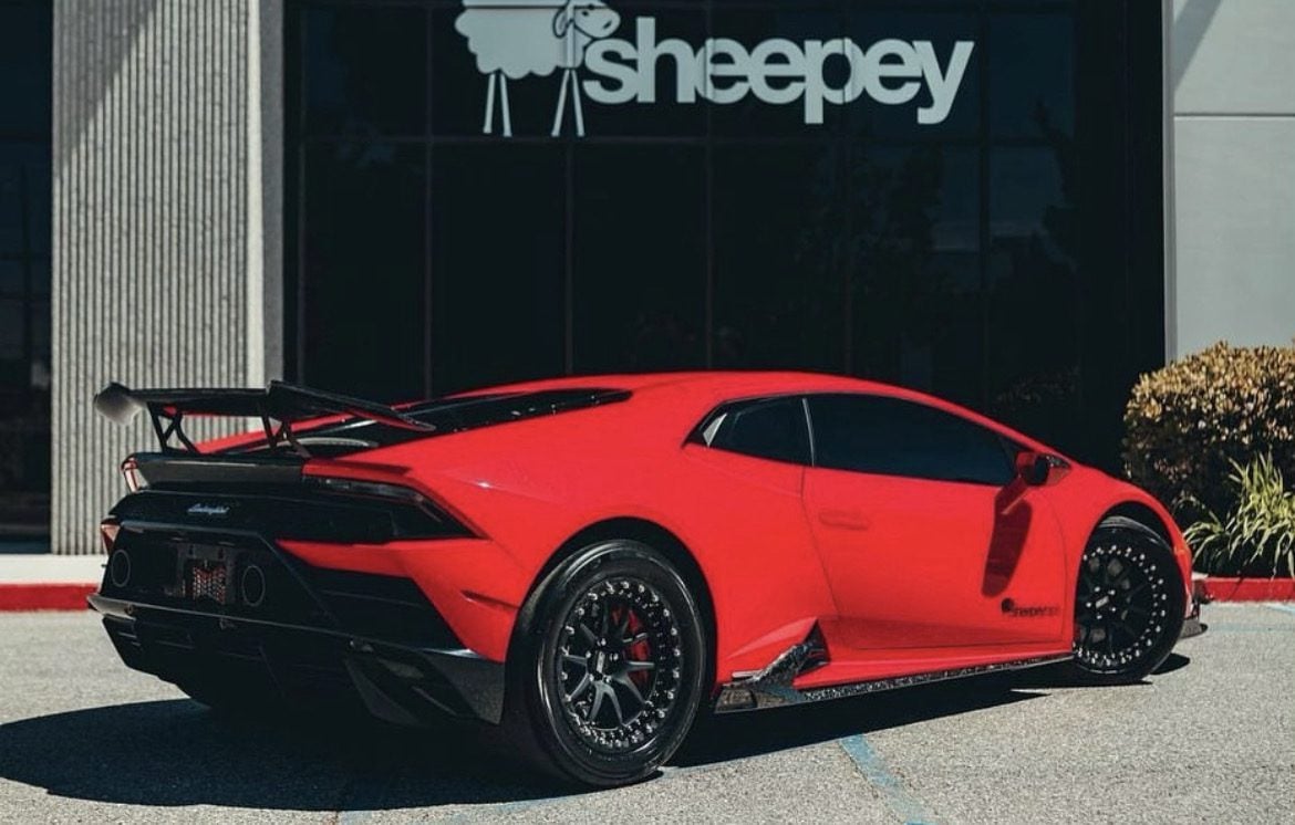 Red Lamborghini Huracan Evo rear three-quarter with carbon rear diffuser