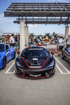 Black McLaren 570S front view with the complete aero kit at a car show