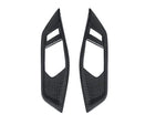 A front view of AUTOTECKNIC DRY CARBON INTERIOR DOOR HANDLE TRIM SET - BMW G82/ G83 M4 2021+ with white background