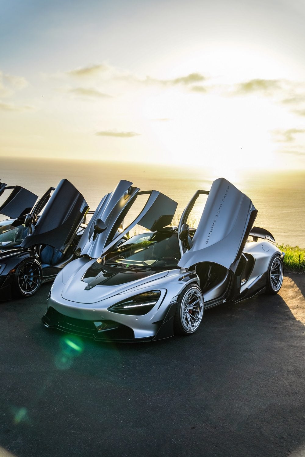 Silver McLaren 720S front three-quarter with the Vision package at sunset, doors up
