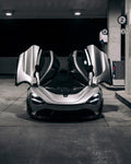 Silver McLaren 720S front view with the Vision package and doors up in a garage