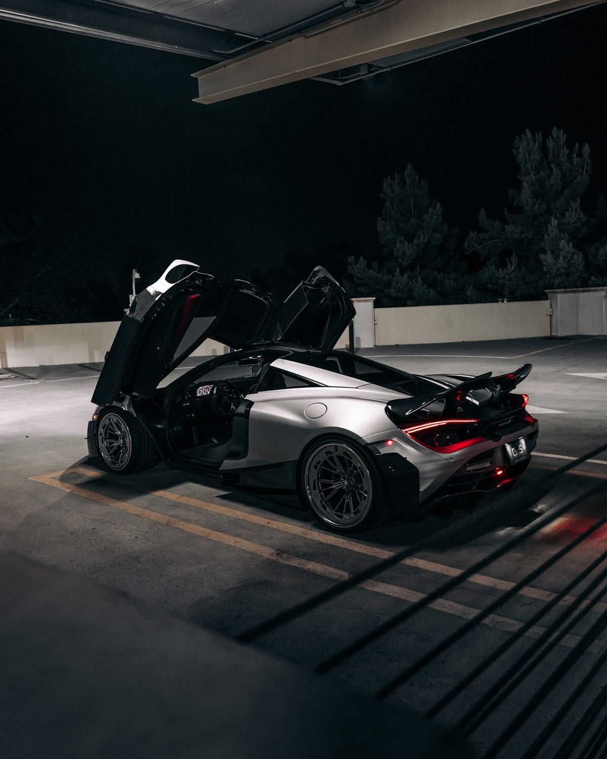 Silver McLaren 720S rear three-quarter with the Vision package and doors up
