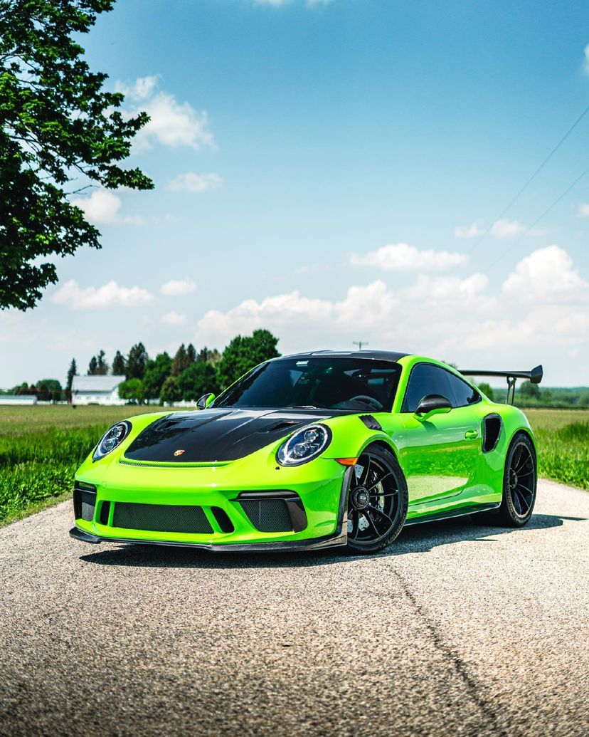 Green Porsche 911 GT3 RS front three-quarter with carbon front lip