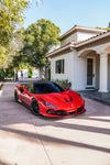 Red Ferrari F8 Tributo front three-quarter with the complete aero kit in a driveway