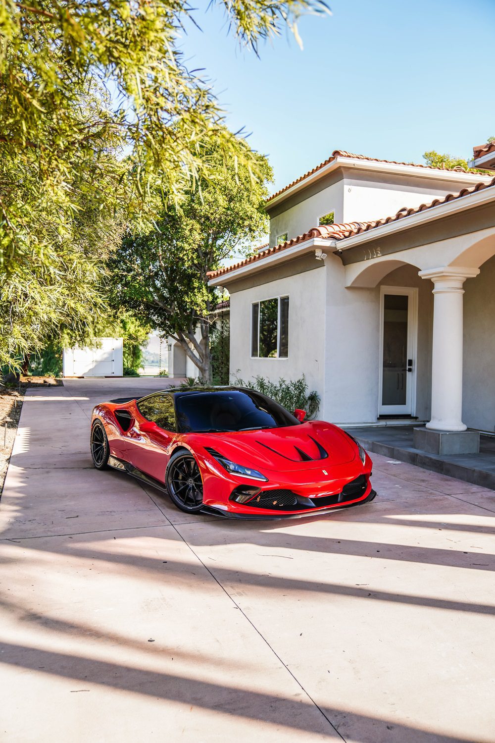 Red Ferrari F8 Tributo front three-quarter with carbon front aero lip