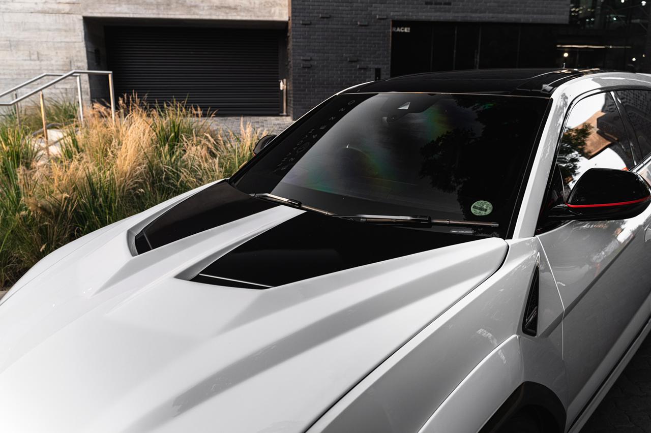Carbon vented hood on a white Lamborghini Urus, close-up