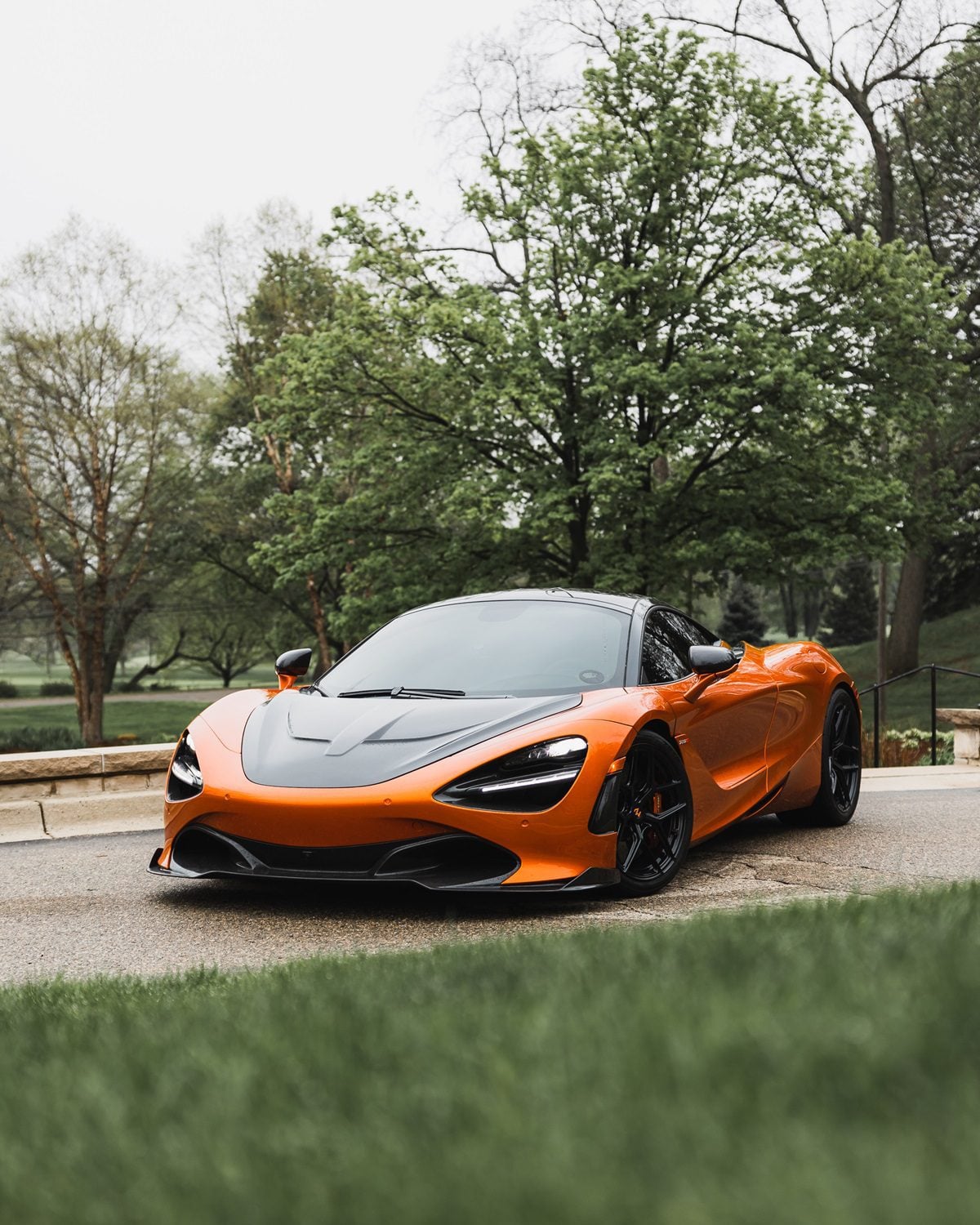 Orange McLaren 720S front three-quarter with carbon race hood