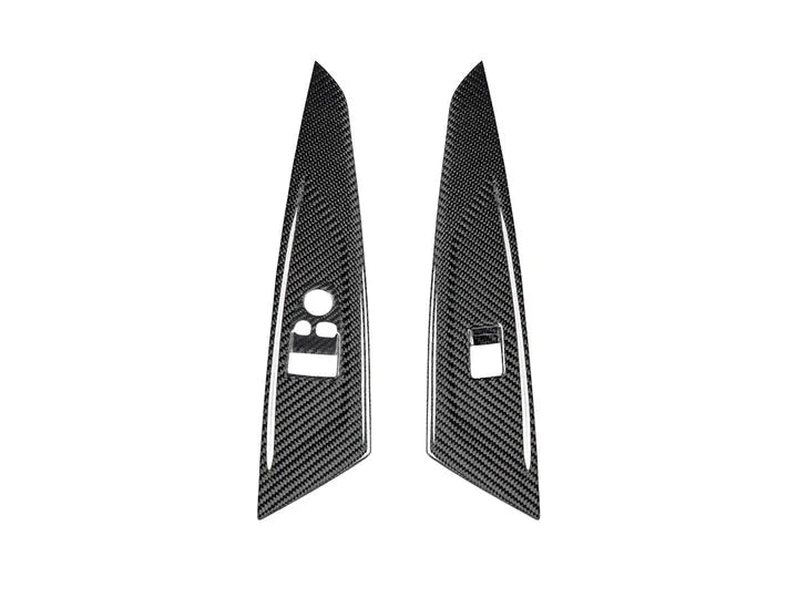 A front view of AUTOTECKNIC DRY CARBON WINDOW SWITCH PANEL TRIM SET - BMW G82 M4 2021+ with white background