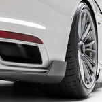 Carbon diffuser corner piece behind 992 Turbo S rear wheel, close-up