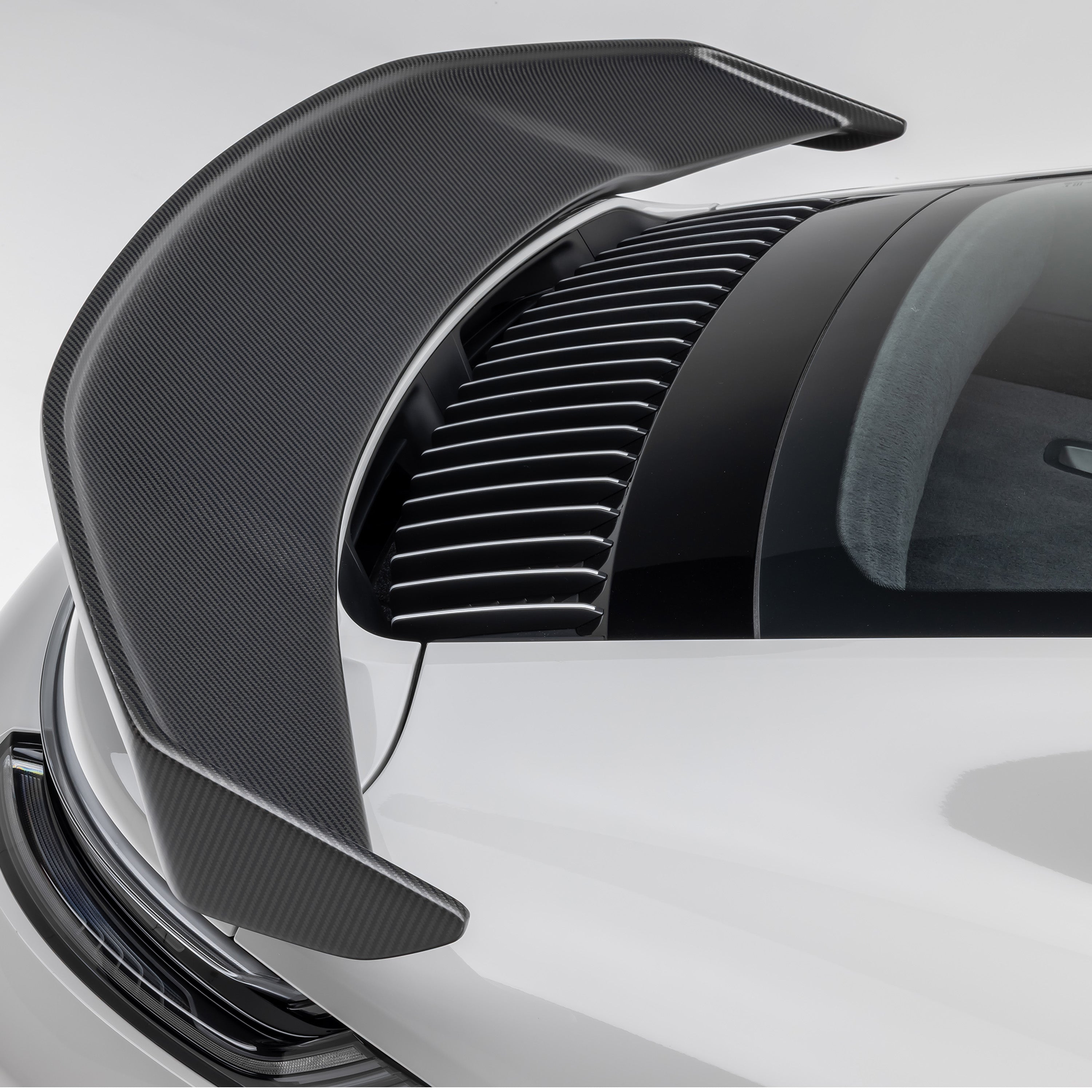 Gloss carbon 992 Turbo S wing blade and endplate, macro detail