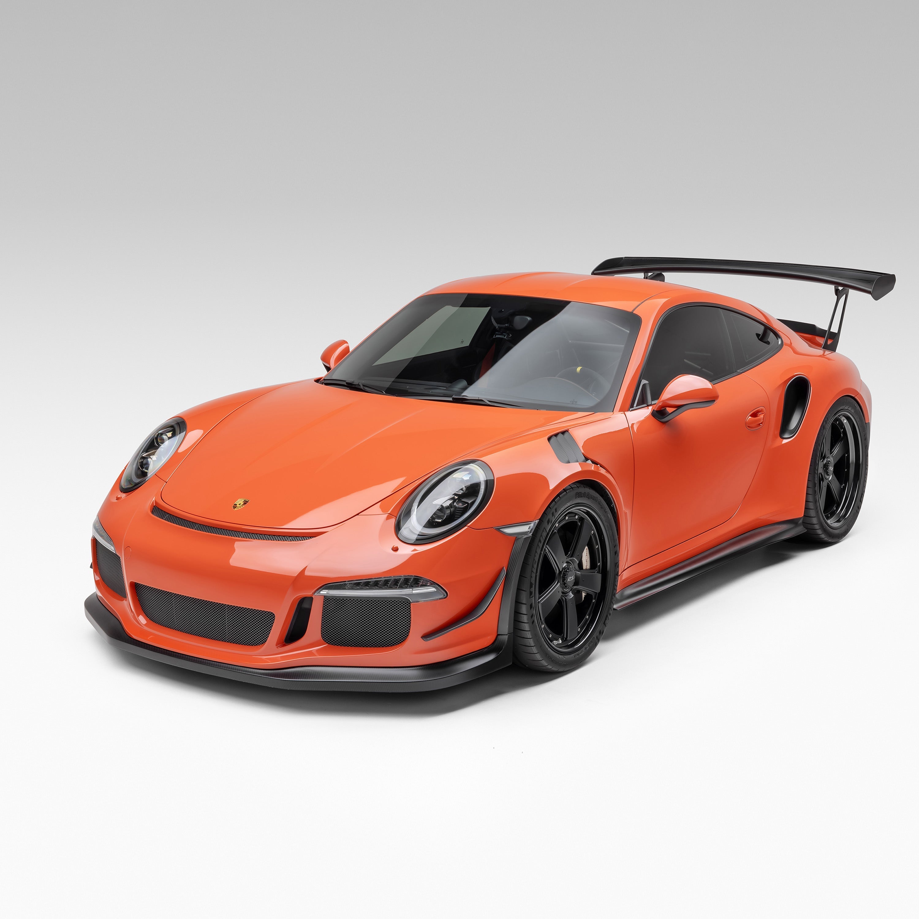 Orange GT3 RS with front apron, front 3/4 view of car