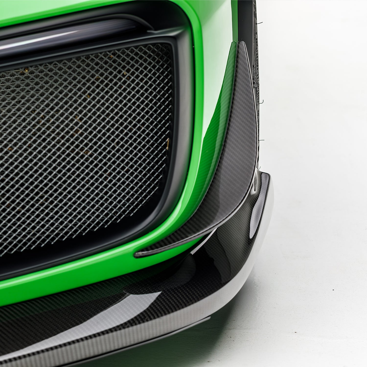 Carbon canard edge beside GT2 RS intake mesh, macro detail