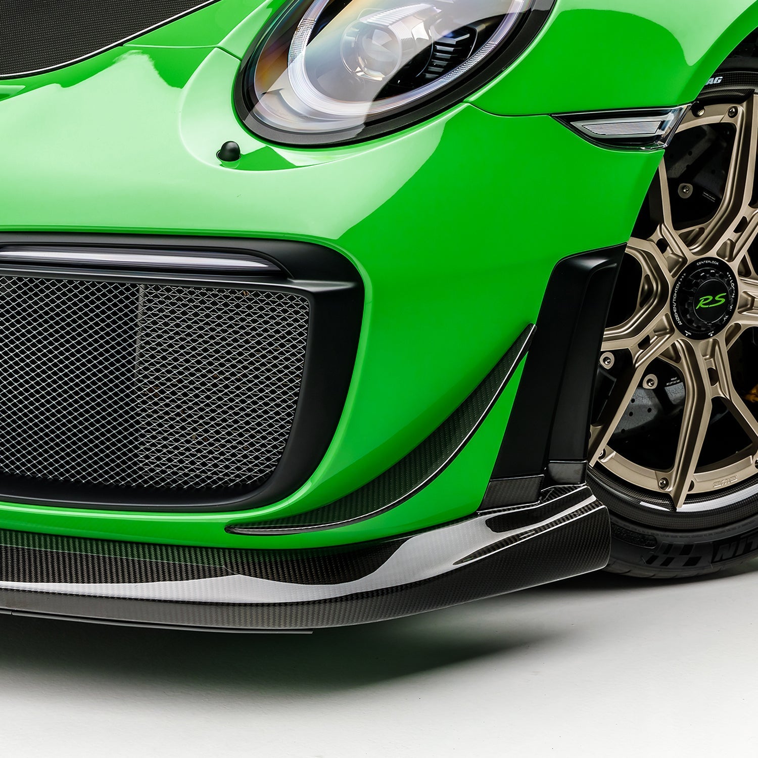 GT2 RS canards stacked on bumper corner, angled close-up