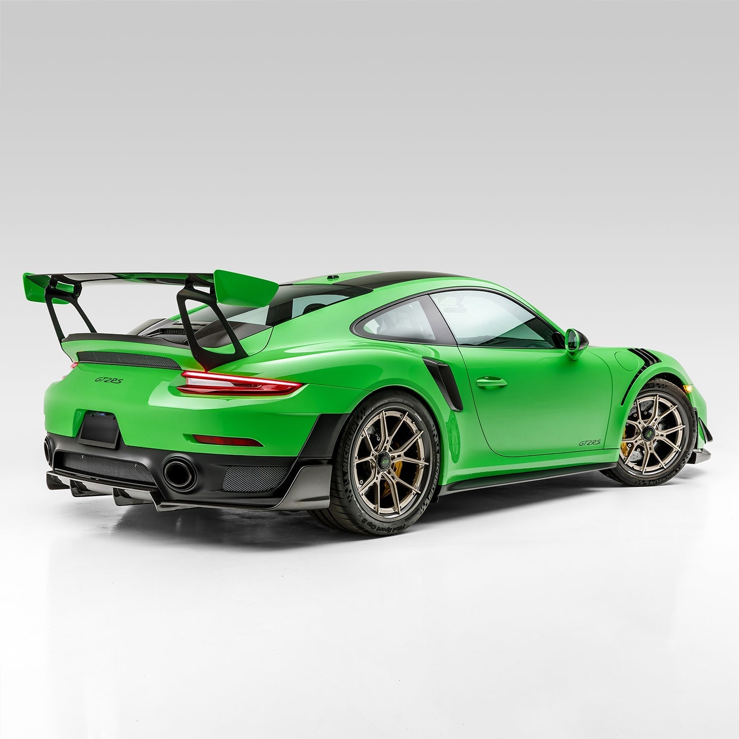 Green GT2 RS with front canards, rear 3/4 view of car