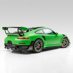 Green GT2 RS with front canards, rear 3/4 view of car