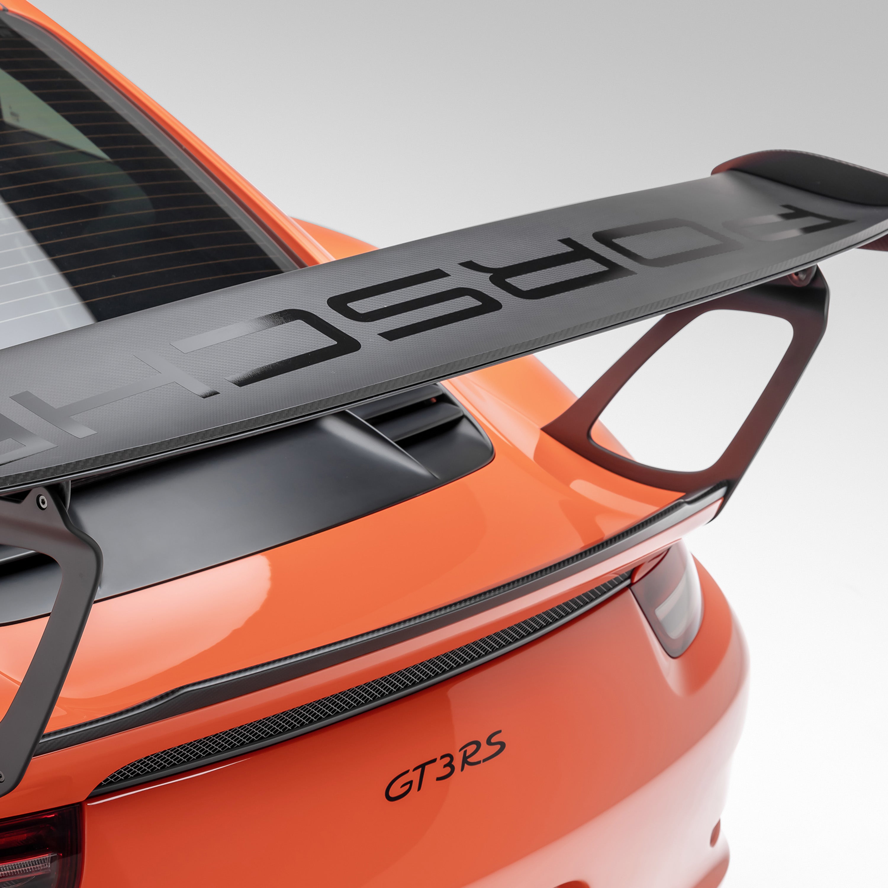 GT3 RS wing blade over GT3RS badge, rear 3/4 close-up