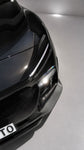 Capristo three-piece carbon fiber front spoiler on black Ferrari Purosangue, close-up