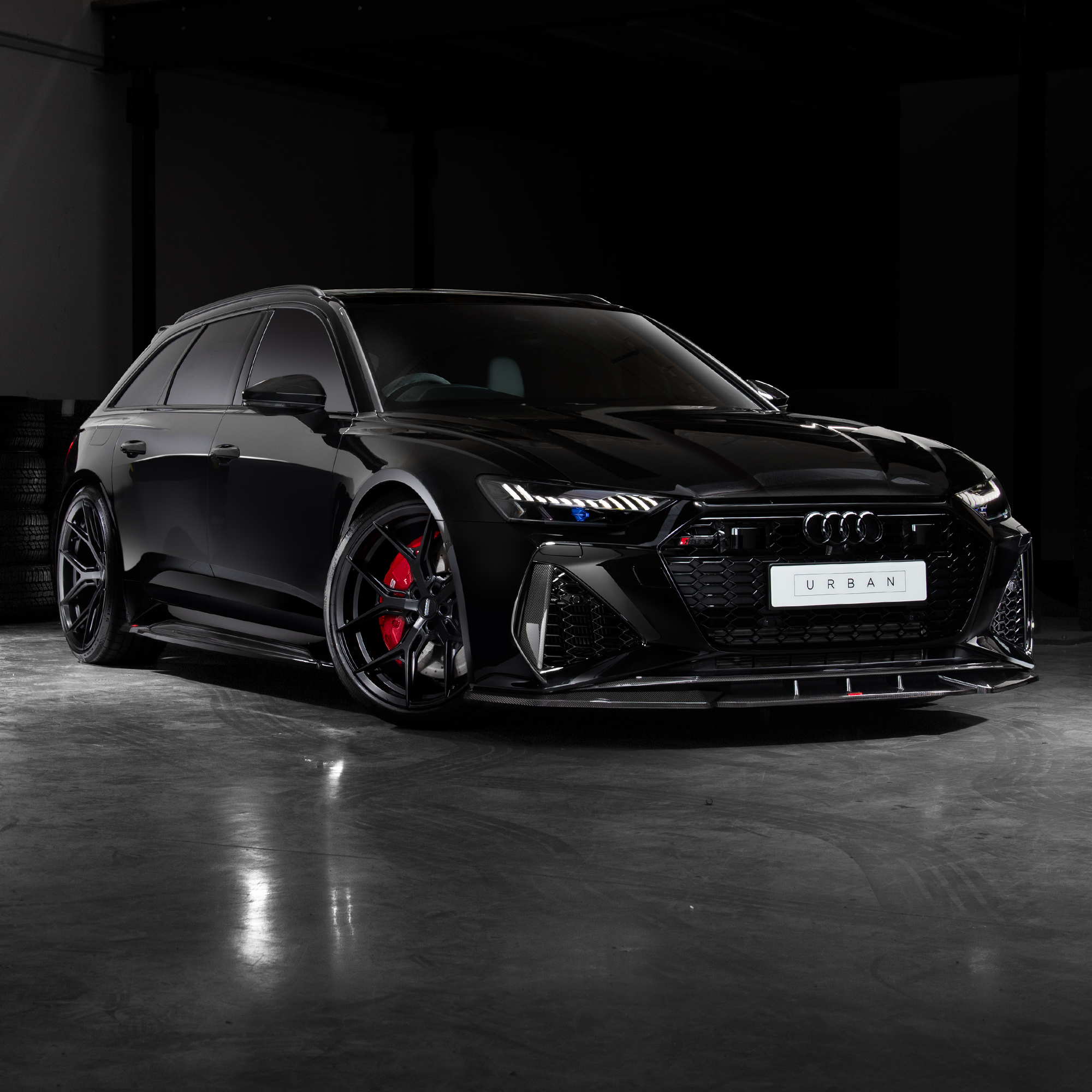 Audi RS6 Avant C8 fitted with Urban carbon fiber side skirts below the doors, front three-quarter view
