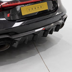 A back view of Urban Automotive Carbon Fiber Rear Diffuser Audi C8 RS7 2020+ fitted on a black car
