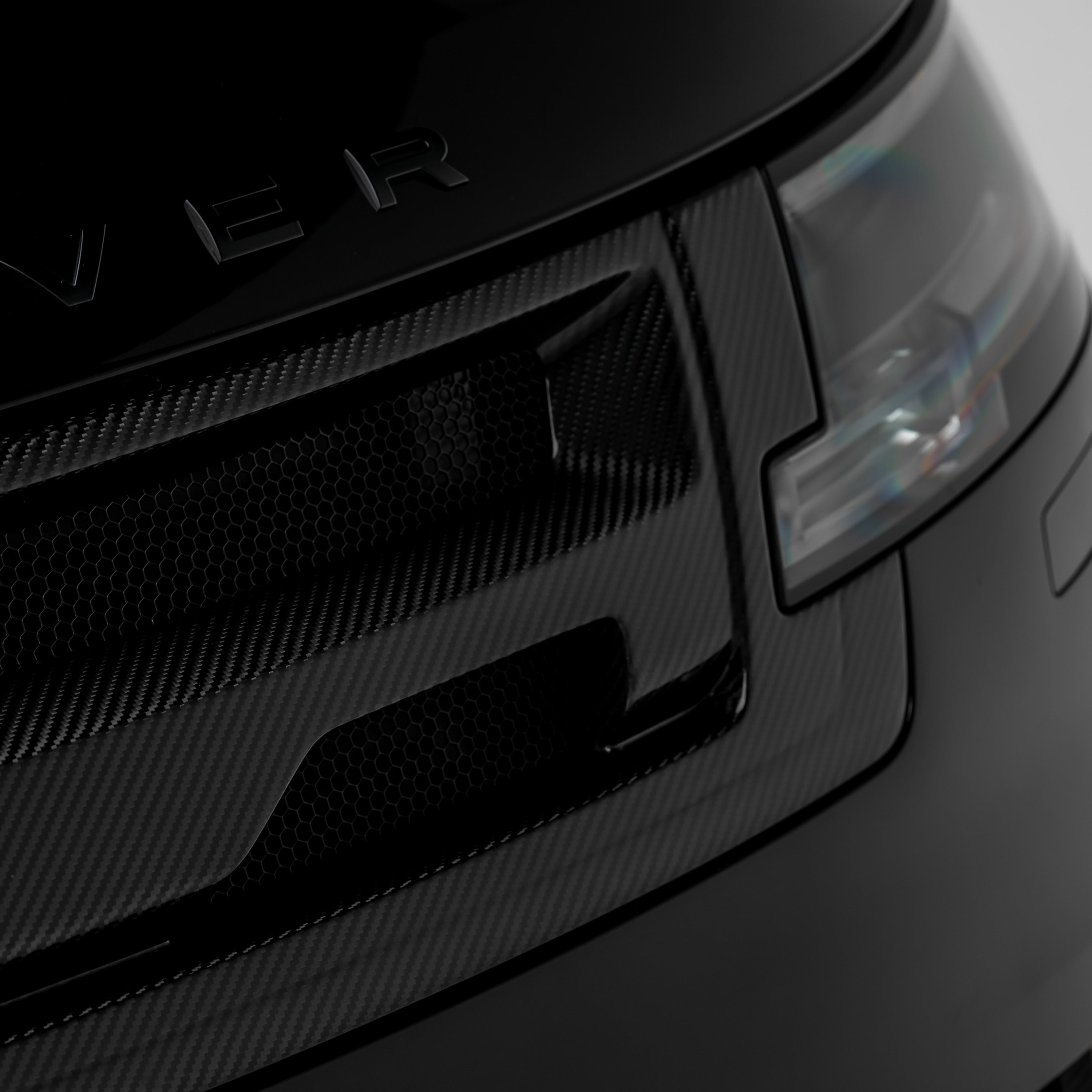 L460 upper grille edge beside headlight, angled close-up