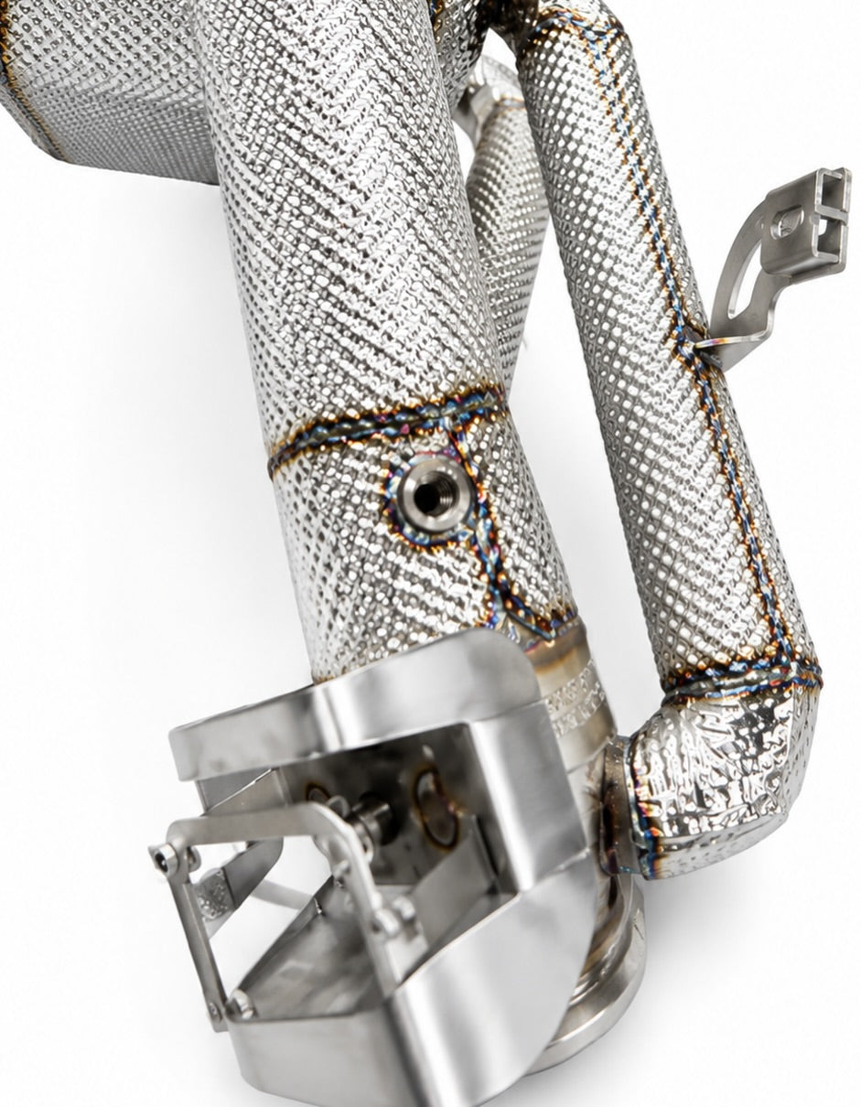 Detail of heat-wrapped inlet pipe and valve actuator bracket on the Revuelto exhaust