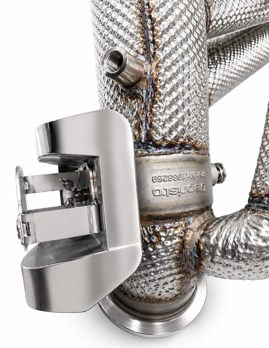 Close-up of valve actuator housing and stamped Capristo part plate on the Revuelto exhaust